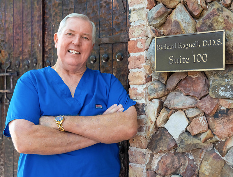 Dr. Richard Ragnell posing next to his name plate in front of iSmile Dental, located in Plano,TX