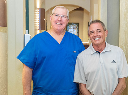 Dr. Ragnell smiling next to a patient who got dental crowns in Plano, TX